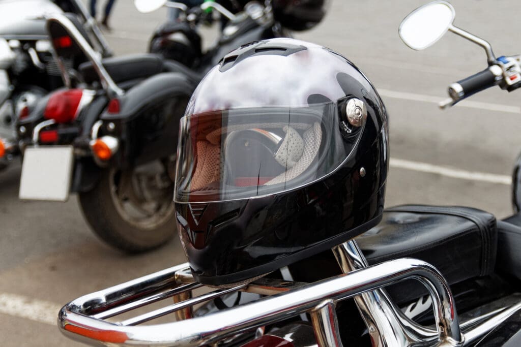 image of a motorcycle helmet on top of a bike - learn how much you should pay for a good motorcycle helmet with Motohorse