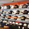 image of helmets for sale on motorcycle shop shelf - learn how much motorcycles cost with Motohorse, a motorcycle & powersports parts and accessories shop