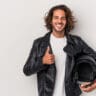 image of man holding a motorcycle helmet - learn how to deal with motorcycle helmet hair with Motohorse