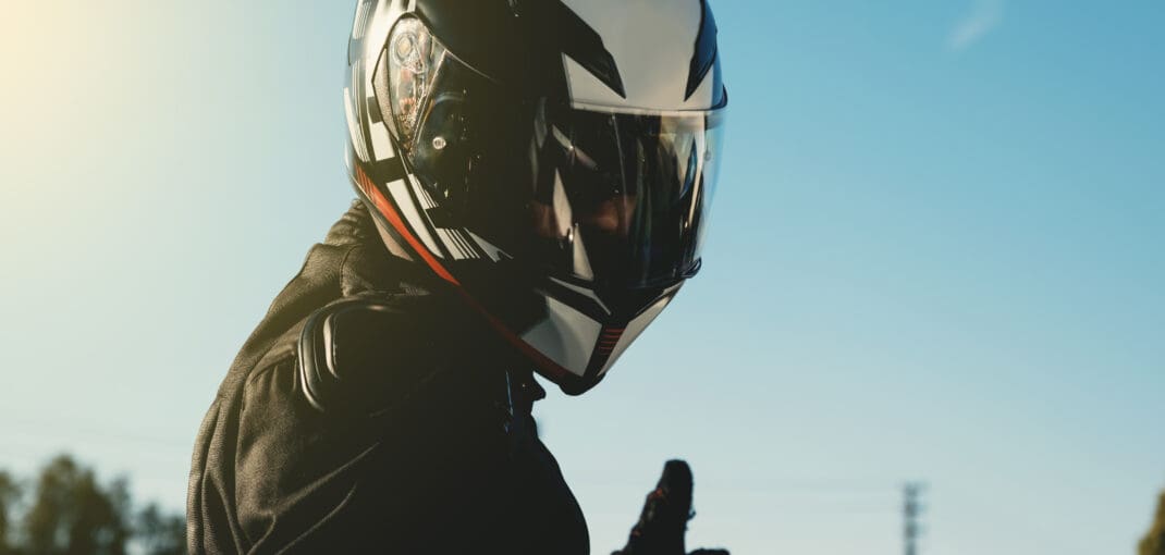 image of a motorcyclist giving the camera a thumbs up - learn how to break in a motorcycle helmet with Motohorse