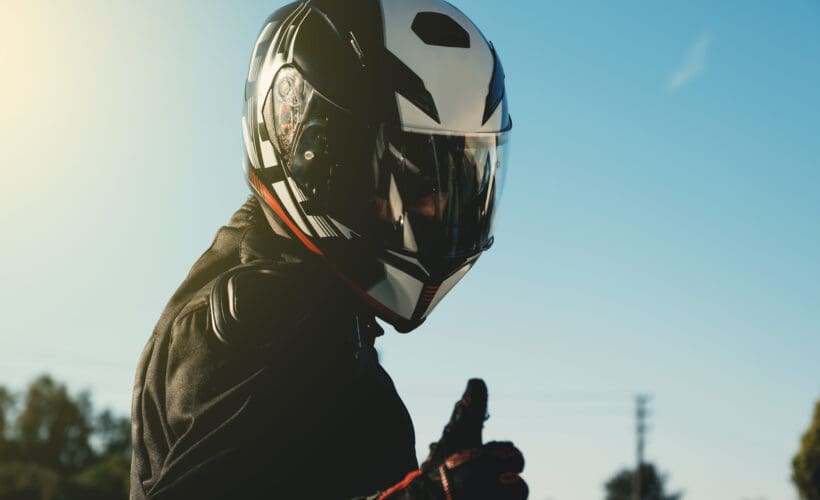 image of a motorcyclist giving the camera a thumbs up - learn how to break in a motorcycle helmet with Motohorse