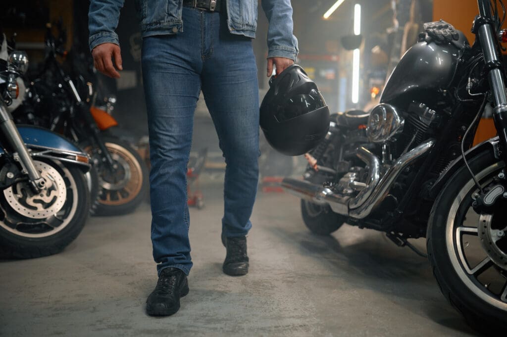 image of a man holding a helmet - motorcycle helmet types with motohorse